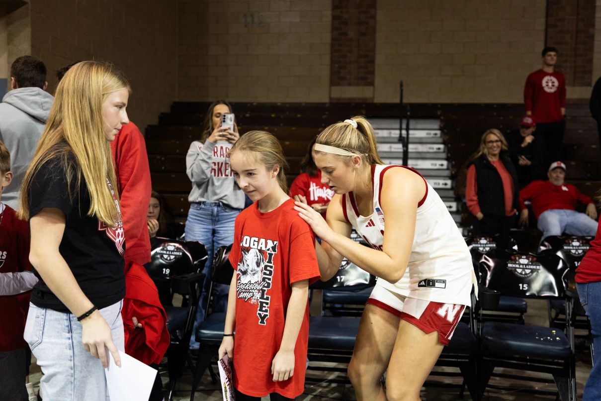 Logan Nissley greeting a young fan wearing a Logan Nissley basketball camp shirt